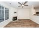 Inviting living room with a corner fireplace, hardwood floors, and a ceiling fan at 2947 Sweetleaf Ln, Johns Island, SC 29455