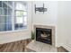 Cozy living room featuring a fireplace, large window, and a TV mount on the wall at 2947 Sweetleaf Ln, Johns Island, SC 29455