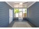 Relaxing screened porch featuring blue walls, a ceiling fan, and a view of the backyard at 2947 Sweetleaf Ln, Johns Island, SC 29455