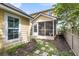 Quaint backyard featuring a screened-in porch, stepping stones, and lush landscaping at 2961 Waterleaf Rd, Johns Island, SC 29455
