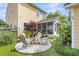 Charming backyard featuring a cozy firepit, screened-in porch, and lush greenery at 2961 Waterleaf Rd, Johns Island, SC 29455