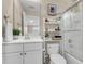 Bright bathroom with a shower and a charming shelving unit with decorative accents at 2961 Waterleaf Rd, Johns Island, SC 29455