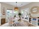 Bright dining area with a round table, woven pendant light, and outdoor access at 2961 Waterleaf Rd, Johns Island, SC 29455