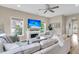 Comfortable living room with fireplace, ceiling fan, and large white sofa at 2961 Waterleaf Rd, Johns Island, SC 29455