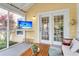 Cozy screened porch with a TV, comfortable seating, and views of the outdoors at 2961 Waterleaf Rd, Johns Island, SC 29455