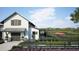 White barn with dark shutters and a green fence in front at 308 Archar St, Summerville, SC 29486