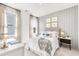 A cozy bedroom featuring a plush bed, stylish decor, and ample natural light at 308 Archar St, Summerville, SC 29486