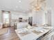Open dining area with a modern chandelier, seating for six, and hardwood floors at 308 Archar St, Summerville, SC 29486