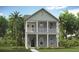 Charming two-story home with a covered balcony, columns, and lush landscaping at 308 Archar St, Summerville, SC 29486