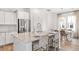 Bright kitchen with white cabinets, stainless steel appliances, and a center island with seating at 308 Archar St, Summerville, SC 29486