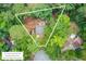 An aerial view of a wooded home surrounded by lot lines and a small backyard deck at 309 Kingbird Rd, Ladson, SC 29456