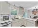 A well-lit kitchen with light countertops, stainless steel appliances, and a garden view at 309 Kingbird Rd, Ladson, SC 29456