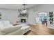 Cozy living room with a stone fireplace and an archway to the dining area at 309 Kingbird Rd, Ladson, SC 29456