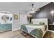 Stylish main bedroom with unique paneling, modern lighting, and a serene, inviting atmosphere at 309 Kingbird Rd, Ladson, SC 29456