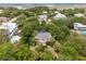 Aerial view of the property featuring the pool, solar panels, and lush surroundings at 3109 Ion Ave, Sullivans Island, SC 29482