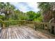 View of the back deck overlooking tropical foliage and palm trees at 3109 Ion Ave, Sullivans Island, SC 29482