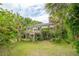 View of the backyard featuring a deck and lush landscaping at 3109 Ion Ave, Sullivans Island, SC 29482