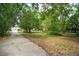 Large, grassy backyard with walking path and trees in the background at 3109 Ion Ave, Sullivans Island, SC 29482