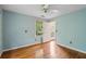 Cozy bedroom with a ceiling fan, hardwood floors, and a door to the outside at 3109 Ion Ave, Sullivans Island, SC 29482