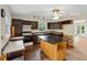 Traditional kitchen with an island, dark cabinets, tile backsplash, and hardwood floors at 3109 Ion Ave, Sullivans Island, SC 29482