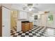 Functional kitchen featuring black and white checkered floors and lots of natural light at 3109 Ion Ave, Sullivans Island, SC 29482