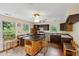 Traditional kitchen featuring a kitchen island, wood cabinets, white appliances, and windows overlooking the garden at 3109 Ion Ave, Sullivans Island, SC 29482