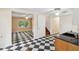 Spacious kitchen featuring black and white checkered floors connecting to an open living area at 3109 Ion Ave, Sullivans Island, SC 29482
