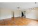 An empty living room with hardwood floors, a ceiling fan, and an open layout into the kitchen area at 3109 Ion Ave, Sullivans Island, SC 29482