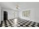 Bright room with black and white checkered floors, a ceiling fan, and an exit door at 3109 Ion Ave, Sullivans Island, SC 29482