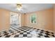 Cozy room with black and white checkered floors, natural light, and a view into the kitchen at 3109 Ion Ave, Sullivans Island, SC 29482