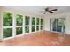 A sunroom featuring lots of windows with backyard views, a ceiling fan, and hardwood floors at 3109 Ion Ave, Sullivans Island, SC 29482