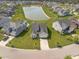 Aerial view of a residential community with a large pond and well-maintained homes at 311 Beachgrass Ln, Summerville, SC 29486