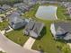 Aerial view of a residential community with a pond, swimming pool, and well-maintained homes at 311 Beachgrass Ln, Summerville, SC 29486