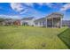 Spacious backyard with a well-maintained lawn and screened-in porch, perfect for outdoor entertaining at 311 Beachgrass Ln, Summerville, SC 29486