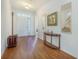 Welcoming entryway boasts gleaming hardwood floors, complemented by elegant console table, mirrors and decor at 311 Beachgrass Ln, Summerville, SC 29486