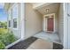 Inviting front entrance with a red door, neutral siding, and tidy landscaping at 311 Beachgrass Ln, Summerville, SC 29486