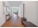 Long hallway with wood flooring, neutral walls, and elegant decor at 311 Beachgrass Ln, Summerville, SC 29486