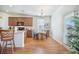 Bright kitchen and dining area with wood floors and granite counters plus direct access to outside at 311 Beachgrass Ln, Summerville, SC 29486