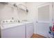 Efficient laundry area with modern appliances, storage shelves and good lighting, designed for easy chore management at 311 Beachgrass Ln, Summerville, SC 29486