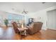 Relaxing living room with comfortable couches, a ceiling fan, and ample natural light streaming through large windows at 311 Beachgrass Ln, Summerville, SC 29486