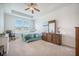 A serene main bedroom with neutral carpet and a tray ceiling, next to a window with natural light at 311 Beachgrass Ln, Summerville, SC 29486