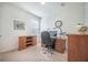Carpeted office space complete with a large wooden desk, rolling chair and storage cabinets in a naturally lit space at 311 Beachgrass Ln, Summerville, SC 29486