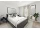 Bright bedroom featuring a sleek bed, a large mirror, and neutral decor creates a serene and stylish space at 327 Calm Water Way, Summerville, SC 29486
