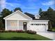Charming single-story home with a covered porch and a two-car garage provides an inviting curb appeal at 327 Calm Water Way, Summerville, SC 29486