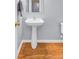 Bathroom with white pedestal sink, mirror, and wood flooring at 327 Eagle Ridge Rd, Summerville, SC 29485