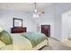This carpeted bedroom features a ceiling fan, two dressers, and an ensuite bathroom at 327 Eagle Ridge Rd, Summerville, SC 29485