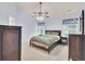 This bedroom features a ceiling fan, two windows, and a complete set of dark wooden furniture at 327 Eagle Ridge Rd, Summerville, SC 29485