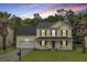 Charming two-story home featuring a welcoming front porch, two-car garage, and beautiful landscaping at 327 Eagle Ridge Rd, Summerville, SC 29485