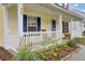 Inviting front porch with classic rocking chairs, framed by a well-maintained lawn and vibrant plants at 327 Eagle Ridge Rd, Summerville, SC 29485