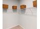 Walk-in closet with a white wire shelf, supported by brackets and filled with woven baskets for stylish storage at 333 Pine Crest View Dr Dr, Summerville, SC 29486